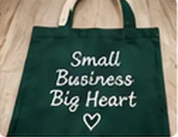 Green tote bag embroidered with 'Small business, big heart'