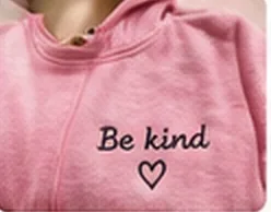 Pink sweatshirt embroidered with 'Be kind'